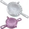 Two dumpling molds, one white and one purple, are shown against a white background. Produktbild-Vorschau