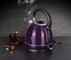 A purple electric kettle is shown steaming next to a glass of tea, with spices scattered around. Podgląd zdjęcia produktu