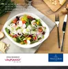 A salad bowl filled with fresh salad, placed on a table with cutlery and bread. Voir les images du produit