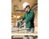 A construction worker is drilling a hole in a wooden plank. Produktbild-Vorschau