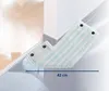 A mop head with blue stripes is shown cleaning a floor near a corner. Produktbild-Vorschau