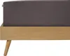 Close-up of a bed frame with a dark gray mattress. Produktbild-Vorschau