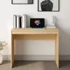 A simple wooden desk with a laptop and books. Podgląd zdjęcia produktu