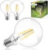 Three clear glass LED light bulbs with visible filament, one in the foreground and two in the background, next to a product box. Produktbild-Vorschau