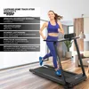 A woman is running on a treadmill in a modern living room. Produktbild-Vorschau