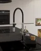 A modern kitchen sink area with a faucet and soap dispenser. Produktbild-Vorschau