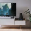 A modern living room setup with a TV, entertainment center, and a router. Náhled obrázku produktu