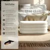 A product shot of a white ottoman with text overlays describing its features, placed on a rug in a bedroom setting. Náhled obrázku produktu
