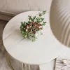 A bouquet of roses and greenery sits on a marble coffee table. Produktbild-Vorschau
