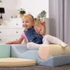 A young child is playing on a set of soft play blocks in a room. Produktbild-Vorschau