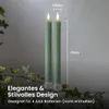 Two green LED candles with clear bases are shown against a gray background, with some green foliage in the foreground. Dimensions are indicated with text overlays. Produktbild-Vorschau