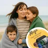A family wrapped in blankets on a beach. Produktbild-Vorschau