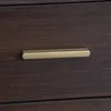 A close-up of a drawer handle on a dark wood cabinet. Produktbild-Vorschau