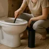 A person is cleaning a toilet with a toilet brush. Anteprima dell’immagine prodotto