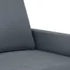 A close-up view of a dark gray sofa's armrest and cushion. Produktbild-Vorschau