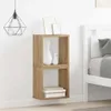 A close-up view of two stacked wooden cube shelves mounted on a white wall, next to a white bed frame. Produktbild-Vorschau