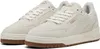 A pair of cream-colored Puma sneakers with brown soles. Produktbild-Vorschau