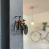 A decorative bicycle-shaped pizza cutter mounted on a wall. Produktbild-Vorschau