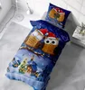 A duvet cover and pillowcase with a winter owl Christmas theme are displayed on a bed. Produktbild-Vorschau