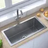 A stainless steel kitchen sink is shown installed in a countertop next to a window. Produktbild-Vorschau