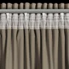 A close-up view of a curtain hanging from a curtain rod. Podgląd zdjęcia produktu