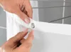 Close-up of hands attaching a shower curtain hook to a shower curtain rod. Produktbild-Vorschau