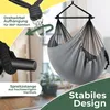 A close-up view of a gray hammock chair, highlighting its features like the swivel suspension and spreader bar, with a blurred indoor background. Produktbild-Vorschau