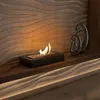A modern living room with a sleek bioethanol fireplace on a wooden shelf, accented by abstract sculptures and ambient lighting. Náhľad obrázku produktu