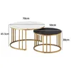 Two round coffee tables of different sizes, one white marble effect and one black marble effect, with gold metal frames, are shown side-by-side. Dimensions are indicated with text labels. Produktbild-Vorschau