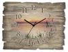A wooden wall clock with a scenic sunset over a lake and reeds. Produktbild-Vorschau
