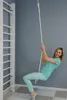 A woman is swinging on a rope attached to a wall-mounted ladder. Voir les images du produit