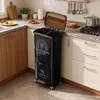 A kitchen scene with a black multi-compartment trash can on the counter. Produktbild-Vorschau