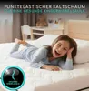 A young girl is lying on a mattress in a bedroom. Produktbild-Vorschau