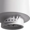 A close-up view of the bottom of a white cylindrical object, showing a white plastic attachment with multiple openings. Náhľad obrázku produktu