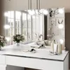 A vanity table with a mirror and makeup products, reflecting a bedroom scene. Produktbild-Vorschau