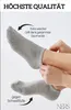 Close-up of a person's legs wearing grey socks, with text overlays highlighting product features. Produktbild-Vorschau