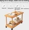 A wooden side table with two shelves, displaying various items like books, a vase, a phone, and a basket with stuffed animals. Produktbild-Vorschau