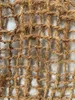 A close-up view of a woven mat made of natural fibers, likely coconut coir, forming a grid pattern. Produktbild-Vorschau