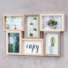 A collage of six framed photos of plants and a word, displayed on a textured gray wall. Produktbild-Vorschau