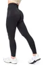 A person wearing black leggings and white sneakers, shown from the side. Voir les images du produit