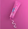 A pink tube of Curaprox toothpaste with a swirl of toothpaste on a pink background. Anteprima dell’immagine prodotto
