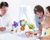 A family is gathered around a baby in a crib, looking at a baby mobile. Náhled obrázku produktu