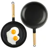 Two frying pans, one with two fried eggs, on a white background. Podgląd zdjęcia produktu