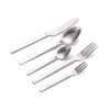 A set of silverware, including a knife, two spoons, and two forks, arranged diagonally on a white background. Produktbild-Vorschau