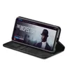 A black flip case for a smartphone, shown open and propped up to display the phone's screen, which shows a movie poster for 'The Inspector'. Produktbild-Vorschau