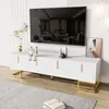 A white TV stand with gold accents holding a large TV and decorative items. Produktbild-Vorschau