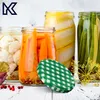 A collection of jars filled with pickled vegetables and a checkered lid. Podgląd zdjęcia produktu