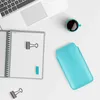 A flat lay of office supplies including a laptop, notebook, coffee cup, and a phone case. Produktbild-Vorschau