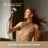 A woman is using a hairdryer in a well-lit room, with her hair blowing in the air. Náhled obrázku produktu