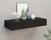 A black floating shelf mounted on a light gray wall, decorated with a framed picture, a white ornamental bowl, a potted plant, and two vases. Voir les images du produit